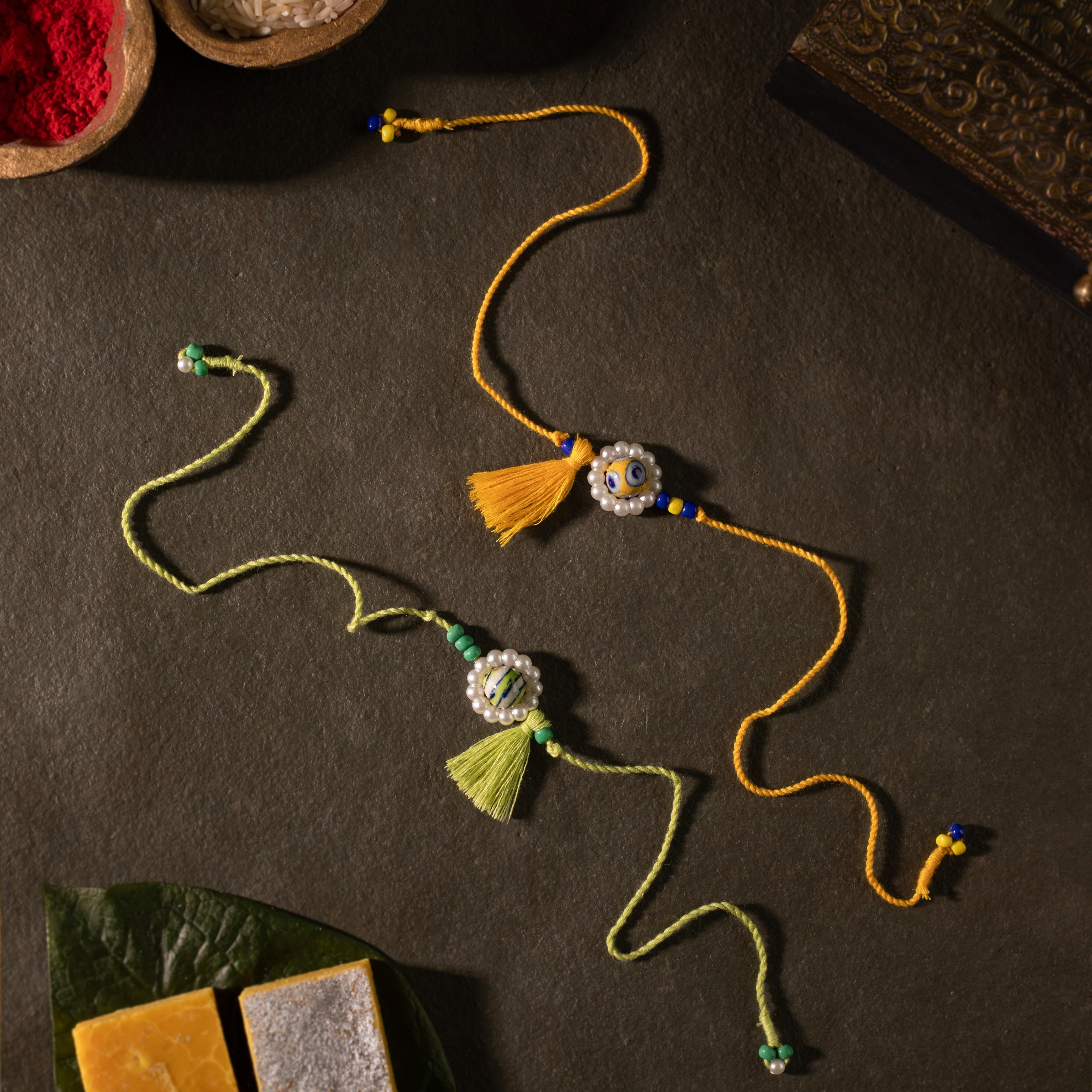 Blue Pottery with Tassel Rakhi (Set of 2)