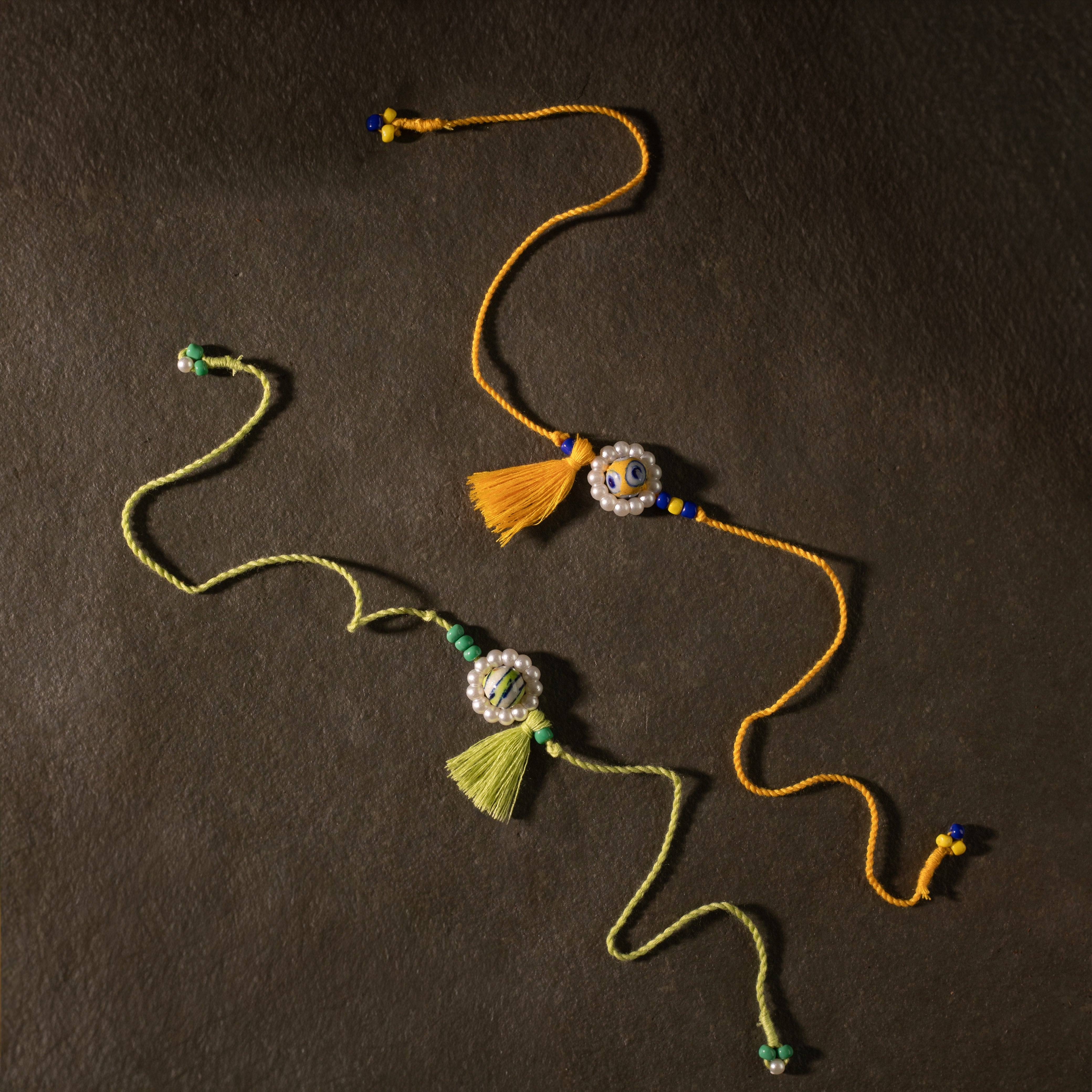 Blue Pottery with Tassel Rakhi (Set of 2)